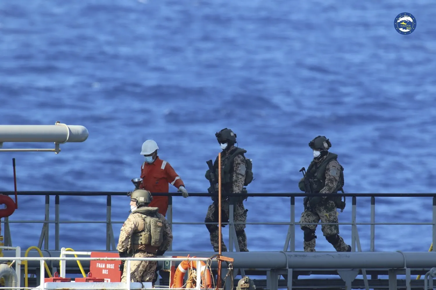 A boarding team inspects the Merchant Vessel Royal Diamond 7, in international waters, 150 kilometers north of the Libyan city of Derna, on Sept. 10, 2020, as the European Union maritime force enforced the UN arms embargo on Libya. (EUNAVFOR Med Irini/Italian Defense Ministry via AP)