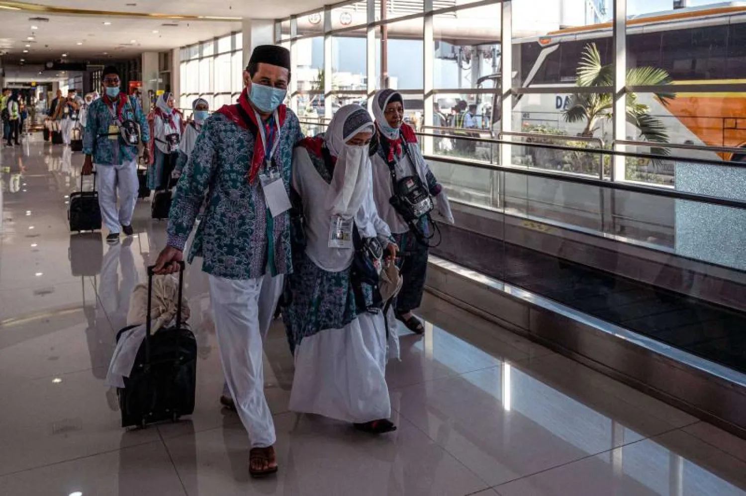 Indonesian pilgrims prepare to depart from Juanda International Airport in Surabaya, June 4, 2022. (AFP)
