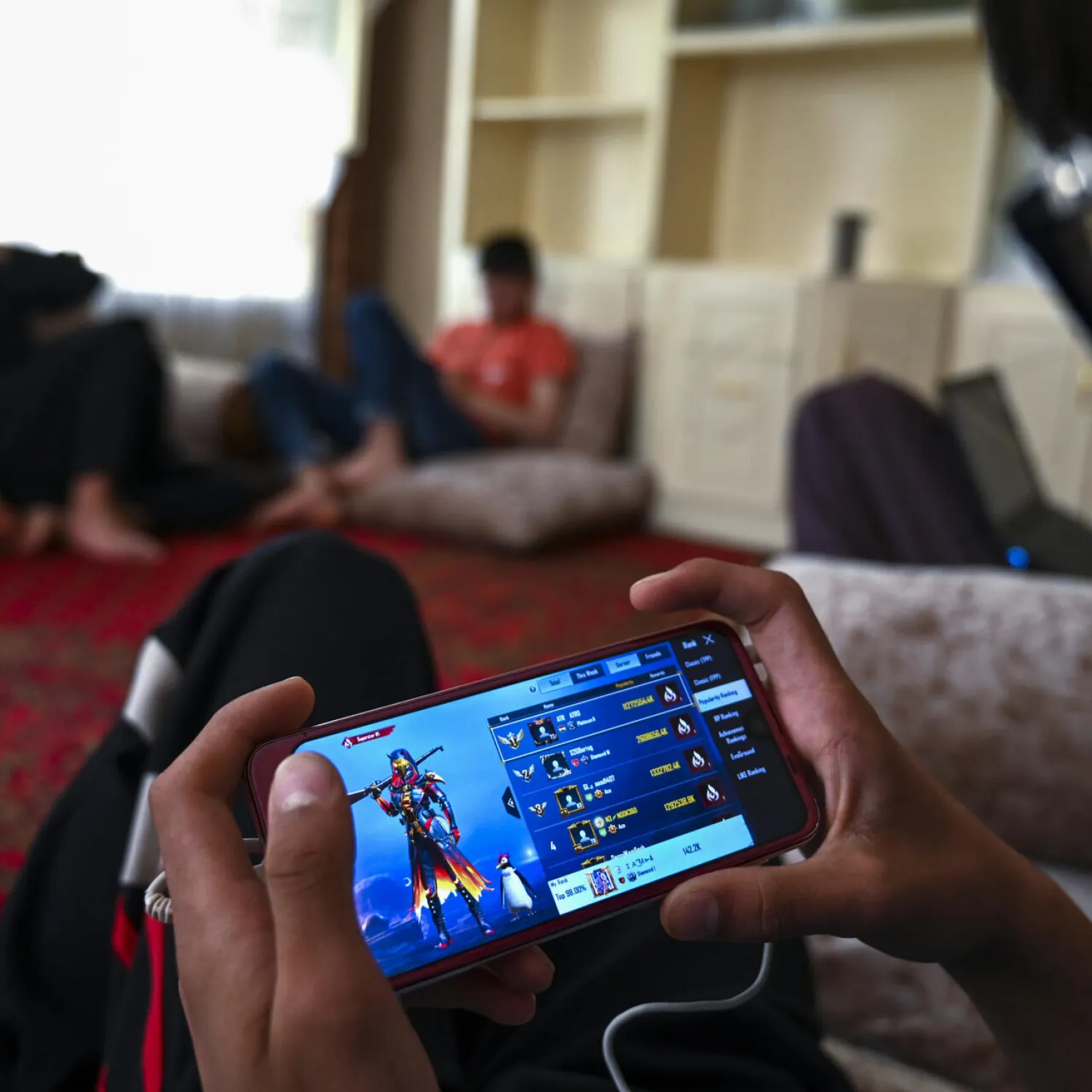 Afghan boys play PUBG on mobile phones in Kabul Wakil KOHSAR AFP
