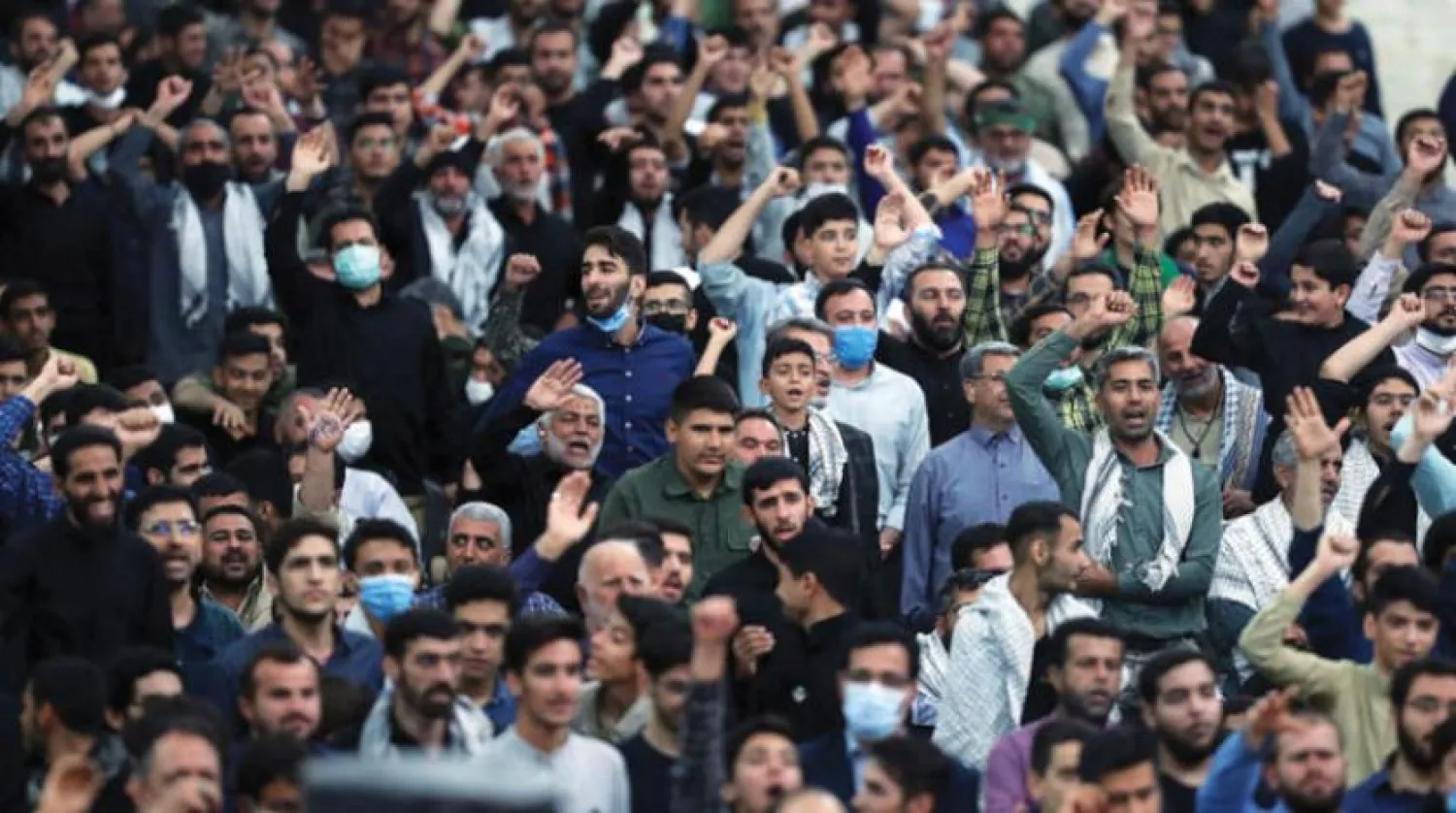 Supporters of Iran’s Supreme Leader Ali Khamenei chant slogans as he delivers a speech at the cemetery of Khomeini's shrine, south of Tehran (EPA)