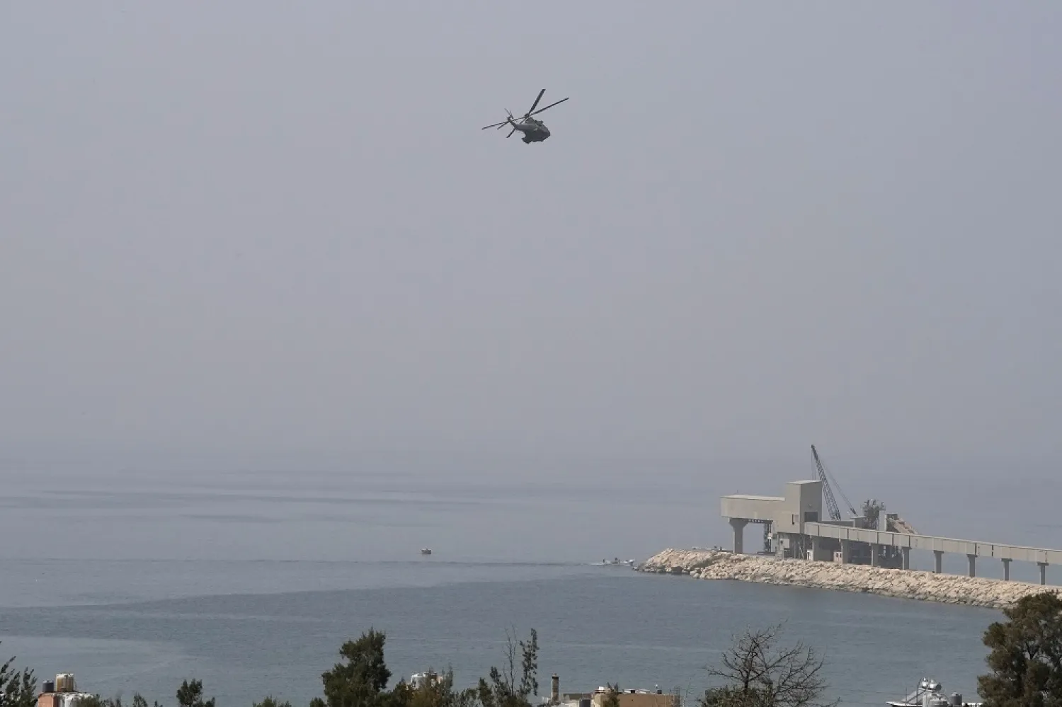 A Lebanese army helicopter takes part in the search of missing people from last week sinking migrant boat, near Tripoli, Lebanon, Wednesday, April 27, 2022. (AP)