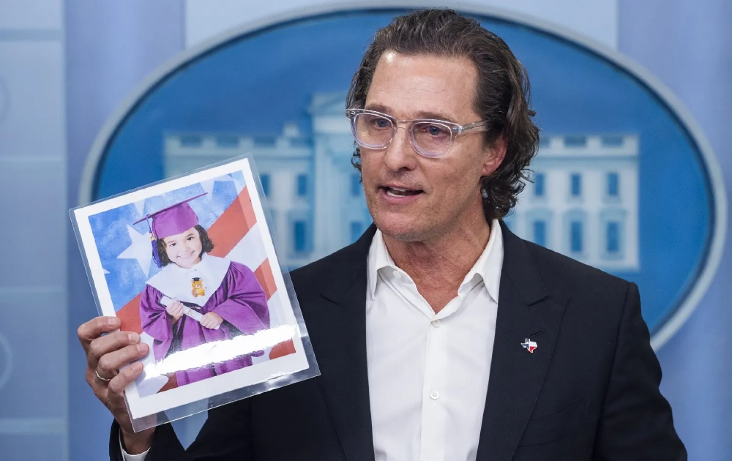 US actor Matthew McConaughey holds a picture of Uvalde shooting victim Alithia Ramirez as he calls for gun responsibility in the White House Press Briefing Room in Washington DC, US, 7 June 2022. (EPA)