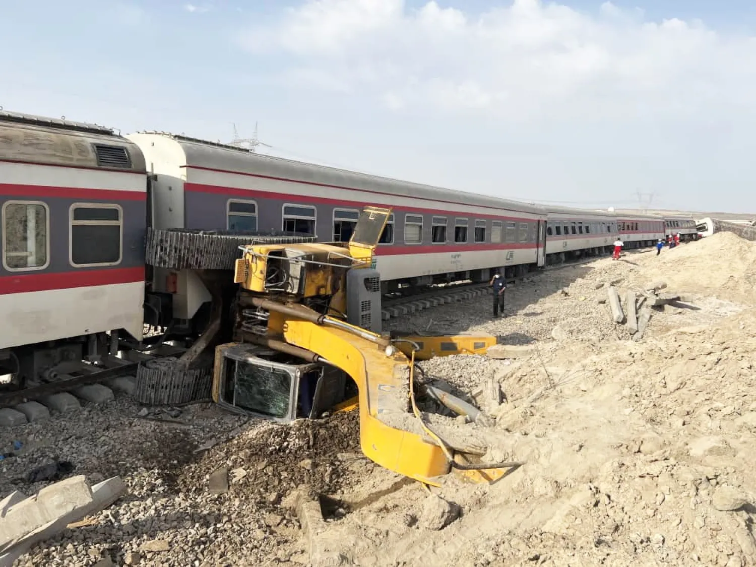 A handout photo made available by the Iranian Red Crescent Society (IRCS) shows the aftermath of the collision between a train and an excavator near Tabas, Yazd province, Iran, 08 June 2022. (EPA/IRCS Handout)
