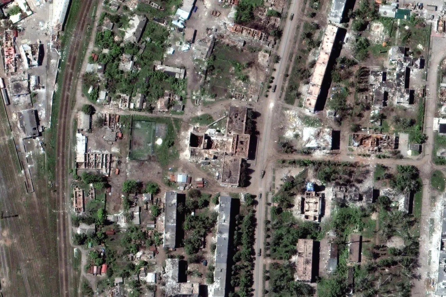 This satellite image provided by Maxar Technologies shows vehicles in a convoy amid extensive building damage throughout the town of Popasna, near Sievierodonetsk in the Luhansk region of Ukraine, on May 25, 2022. (Satellite image ©2022 Maxar Technologies via AP, File) 
