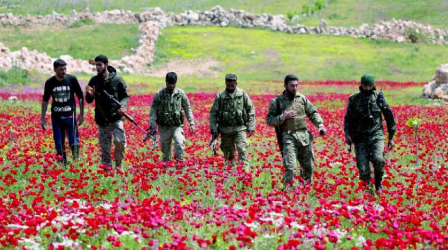 Fighters of the Turkish-backed Syrian opposition in a field in Jabal al-Zawiya in Idlib countryside, April 2020 (Reuters)