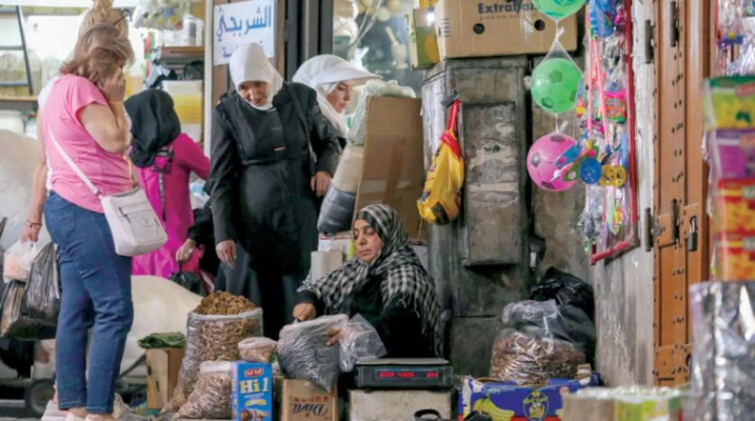 People shop at a market in Damascus on Tuesday. (AFP)
