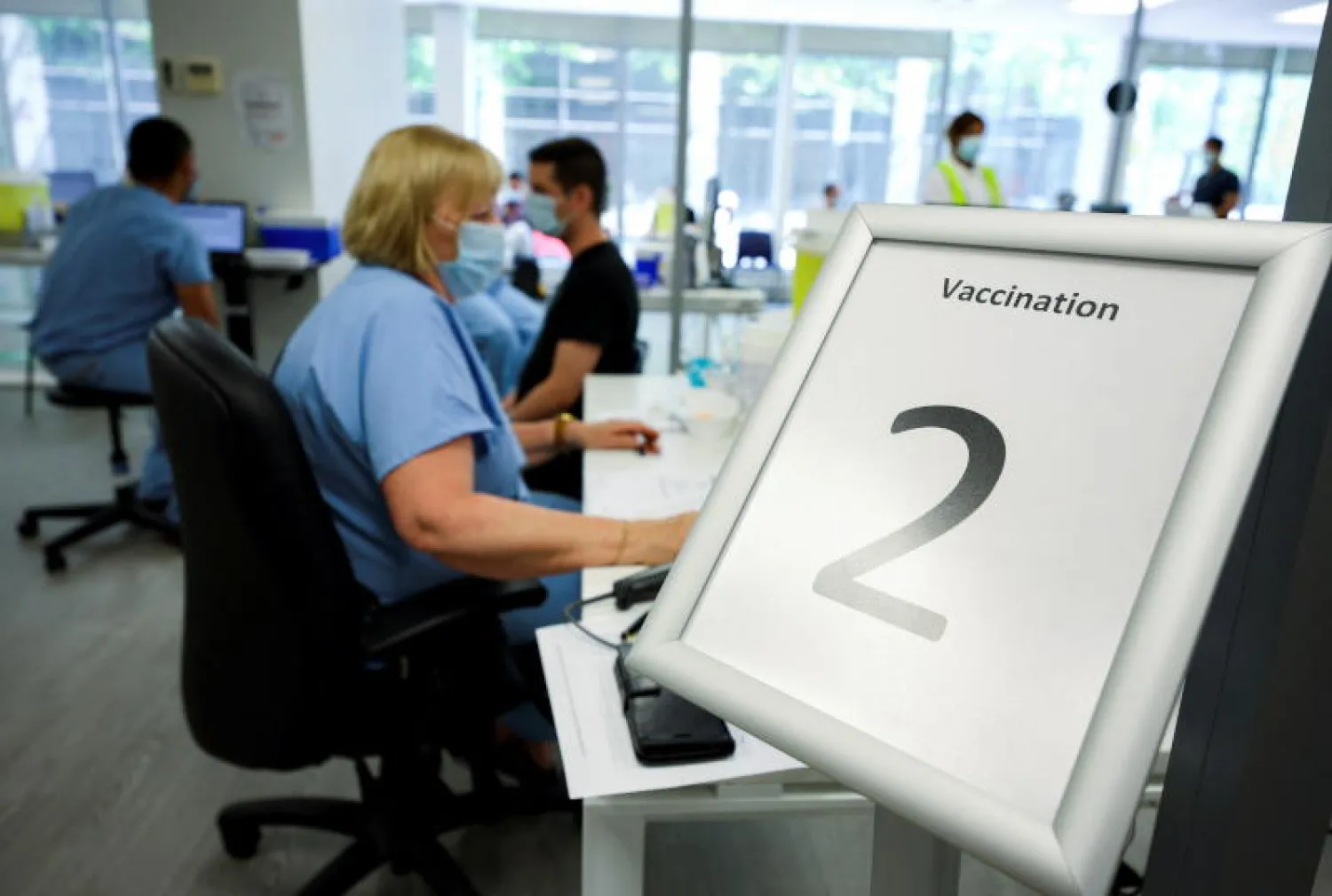 موظفون يعملون داخل مركز لتلقي اللقاحات المضادة لفيروس جدري القردة (رويترز)