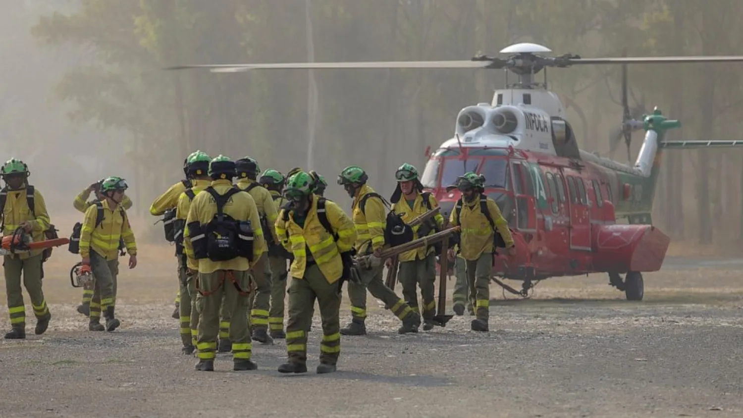Firefigters walk in the area of a wildfire in Pujerra, Malaga, on Thursday, June 9, 2022. (Alex Zea, Europa Press via AP)
