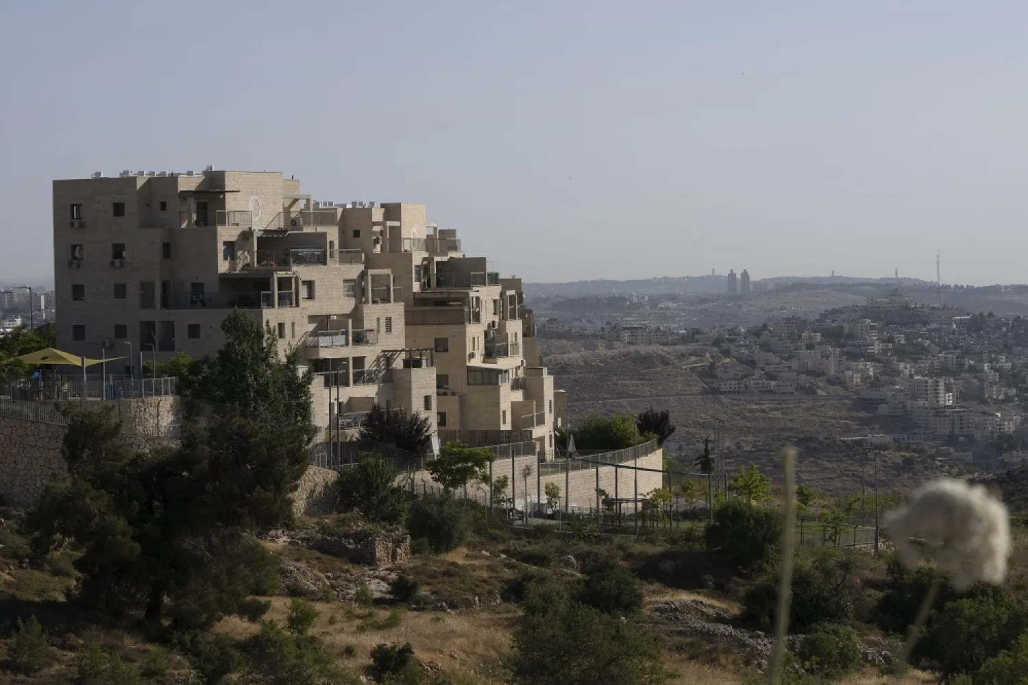 Palestinian buildings are seen at right, behind a section of the West Bank Jewish settlement of Efrat, foreground, Thursday, June 9, 2022. (AP)