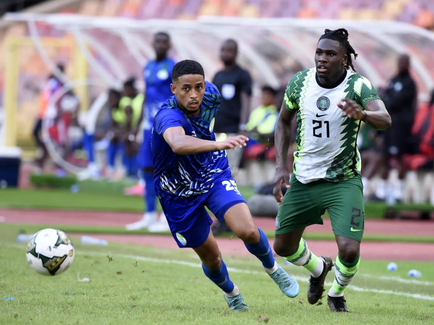 Sierra Leone forward Jonathan Morsay (L) is chased by Nigeria defender Calvin Bassey (R) during a 2023 Africa Cup of Nations Group A qualifier in Abuja on June 9, 2023. PIUS UTOMI EKPEI AFP
