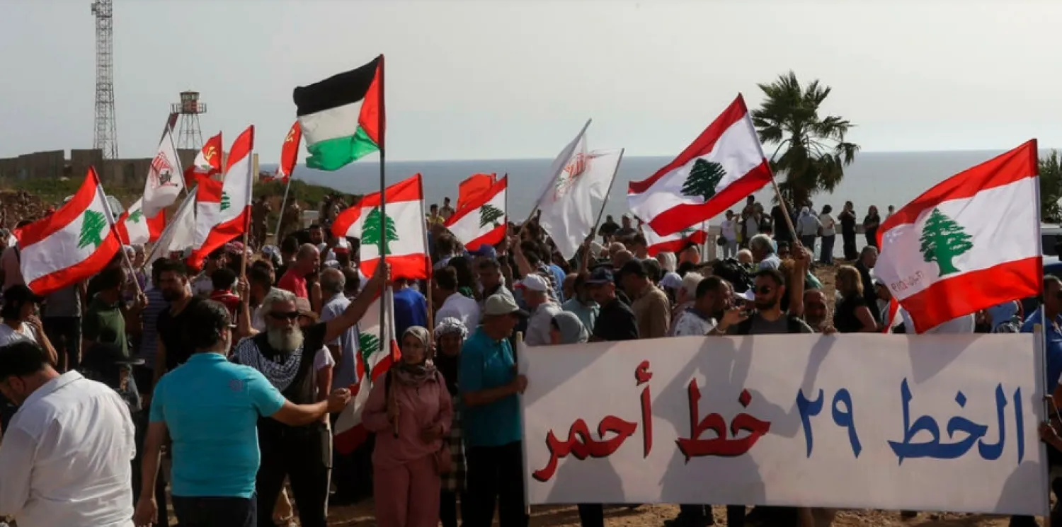Lebanese protesters take part in a demonstration at the Lebanese southernmost border area of Naqura, on June 11, 2022, days after Israel moved a gas production vessel into an offshore field, a part of which is claimed by Lebanon. (Photo by MAHMOUD ZAYYAT / AFP)
