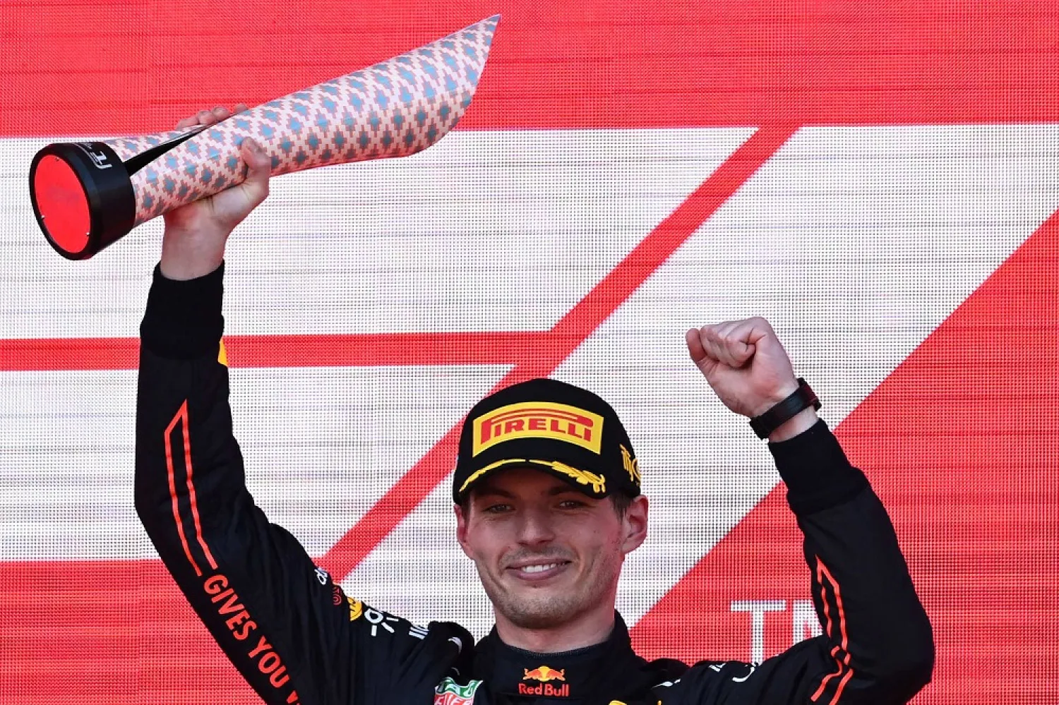 Red Bull's Dutch driver Max Verstappen celebrates with the trophy after winning the Formula One Azerbaijan Grand Prix at the Baku City Circuit in Baku on June 12, 2022. (AFP) 