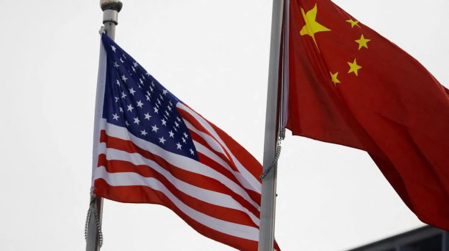 Chinese and US flags flutter outside the building of an American company in Beijing, China January 21, 2021. (Reuters)
