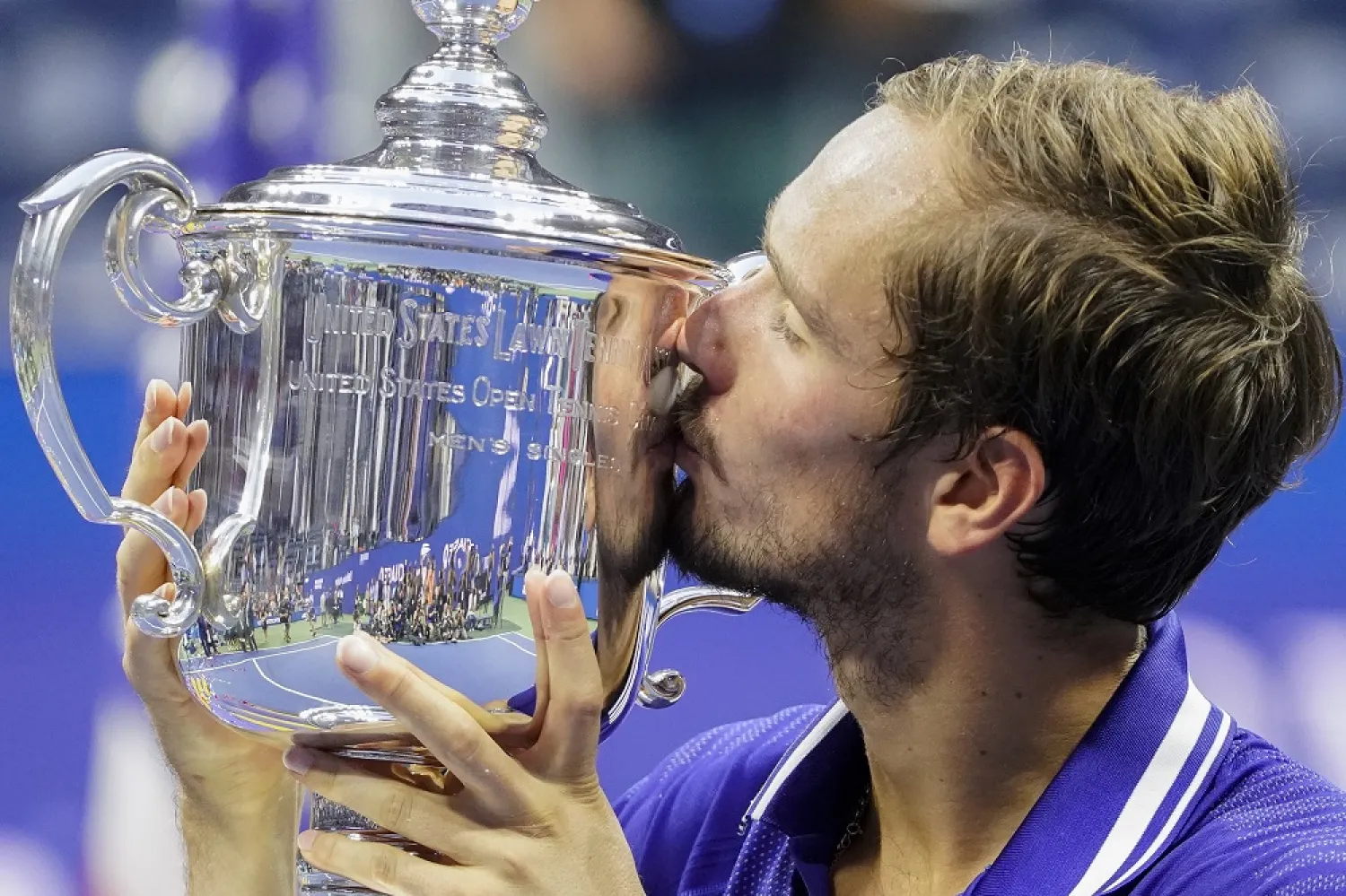 Daniil Medvedev, of Russia, kisses the championship trophy after defeating Novak Djokovic, of Serbia, in the men's singles final of the US Open tennis championships, Sunday, Sept. 12, 2021, in New York. (AP)