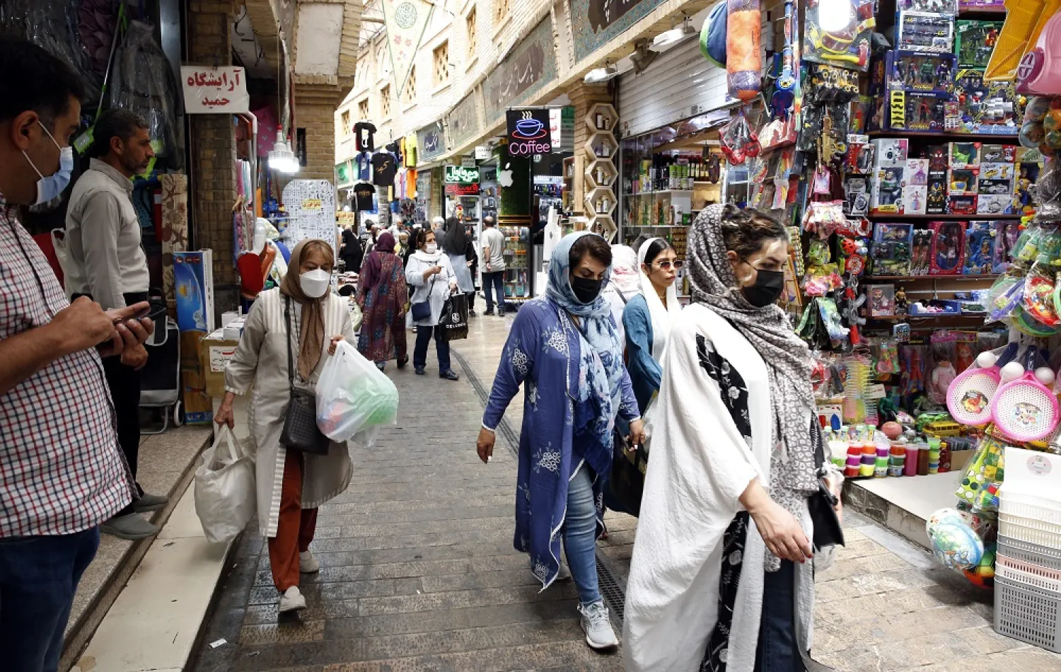 Iranians go shopping in a bazaar Tehran, Iran, 13 June 2022. (EPA)