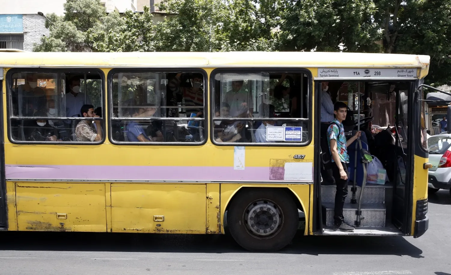 Iranians ride a bus in Tehran, Iran, 13 June 2022. (EPA)