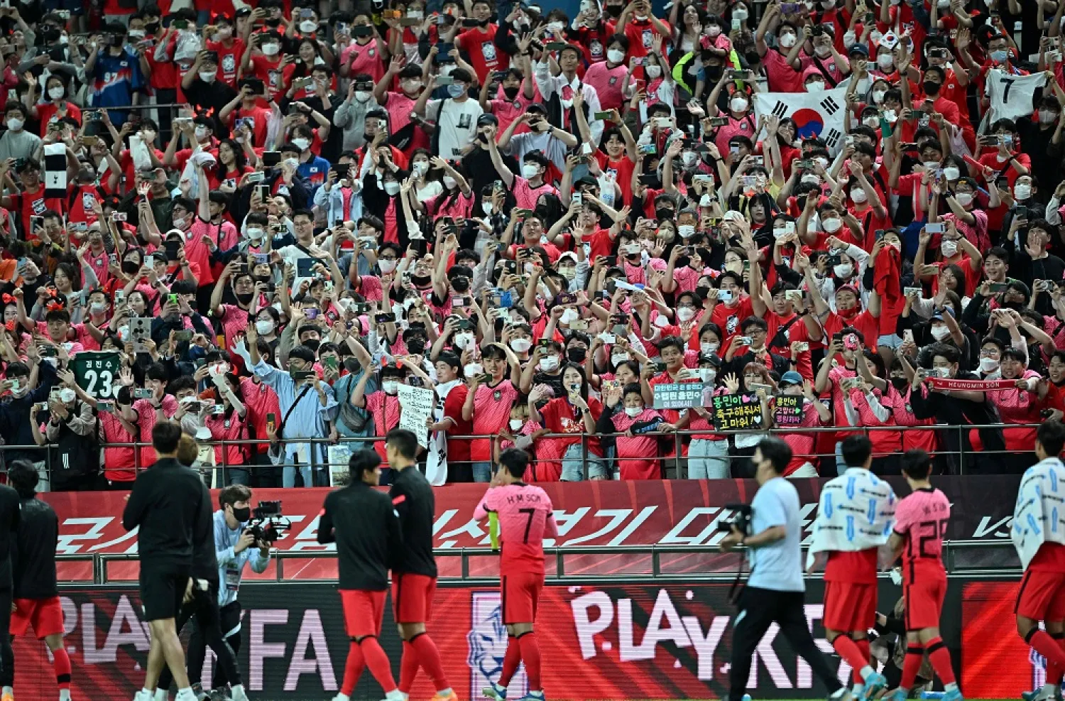 South Korea's Son Heung-min (C bottom) waves to his fans after a friendly football match between South Korea and Egypt in Seoul on June 14, 2022. (AFP)