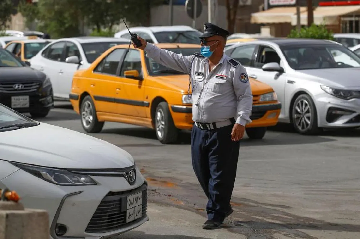 n Iraqi policeman directs traffic in the streets of the capital Baghdad on May 31, 2022. PHOTO: AFP
