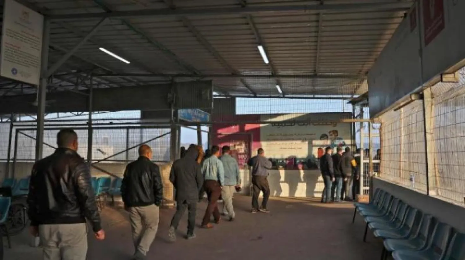 عمال فلسطينيون يغادرون المحطة الأخيرة في بيت حانون شمال قطاع غزة قبل أن يصلوا إلى إسرائيل عبر معبر إيرز (أ.ف.ب)