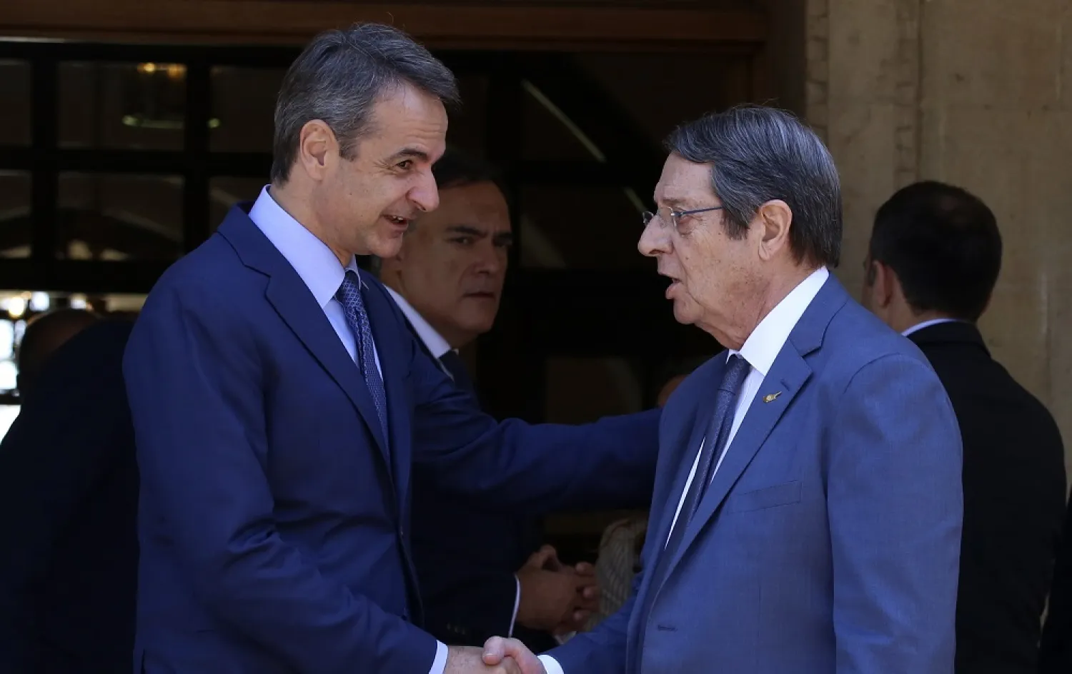 Cypriot President Nicos Anastasiades, right, and Greek Prime Minister Kyriakos Mitsotakis shake hands after their meeting at the Presidential Palace in Nicosia, Cyprus, Friday, June 17, 2022. (AP)
