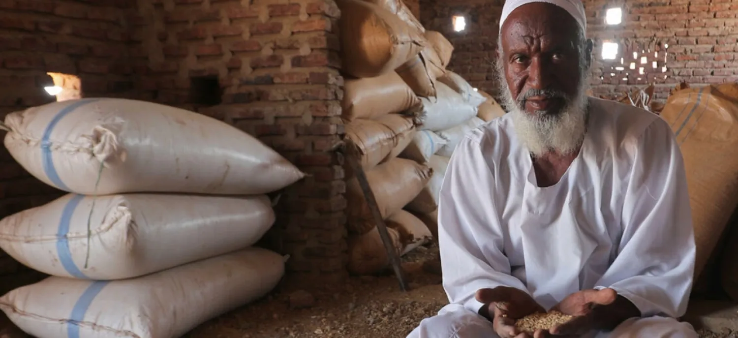 Sudanese farmer Modawi Ahmed is seen inside his granary in the village of Al-Laota, southwest of the capital Khartoum. AFP