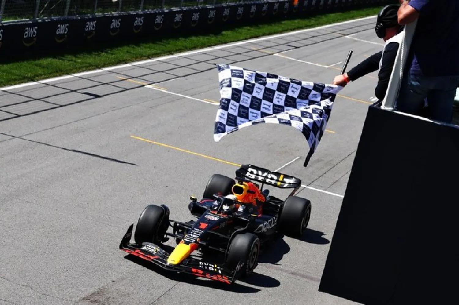 Max Verstappen, of the Netherlands, driving for Red Bull Racing, takes the chequered flag at Circuit Gilles Villeneuve to win the F1 Grand Prix of Canada, Montreal, Quebec, June 19, 2022. (AFP)
