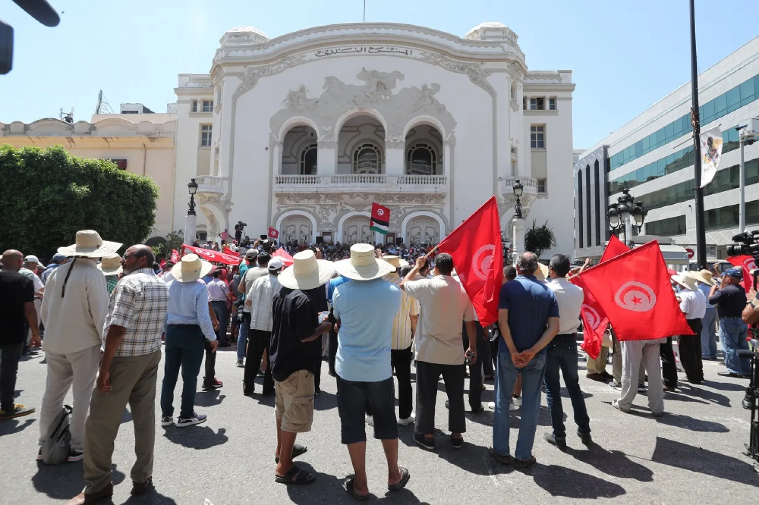 Tunisians shout slogans and carry Tunisian flags during a protest against Tunisian President Kais Saied and the constitutional referendum, which will be held on 25 July, in Tunis, Tunisia, 19 June 2022. (EPA)
