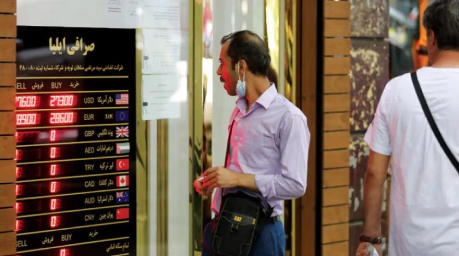 An Iranian follows the fluctuations of currency rates in front of a money exchange shop in the capital, Tehran, last Wednesday (AFP)

