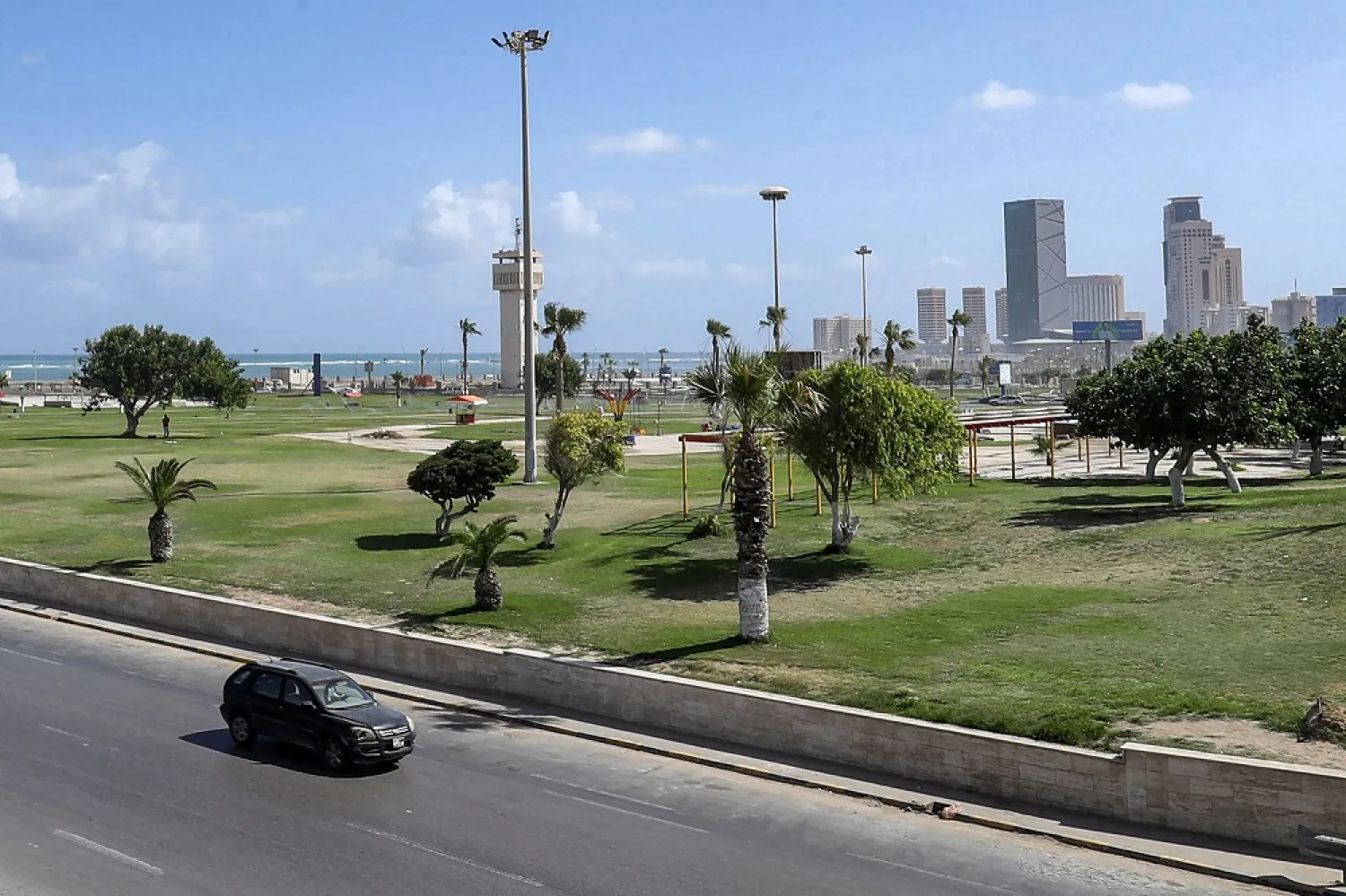 Vehicles drive along a road at the Souk al-Thalath (Tuesday market) district in the center of Libya's capital Tripoli on June 11, 2022. (AFP)