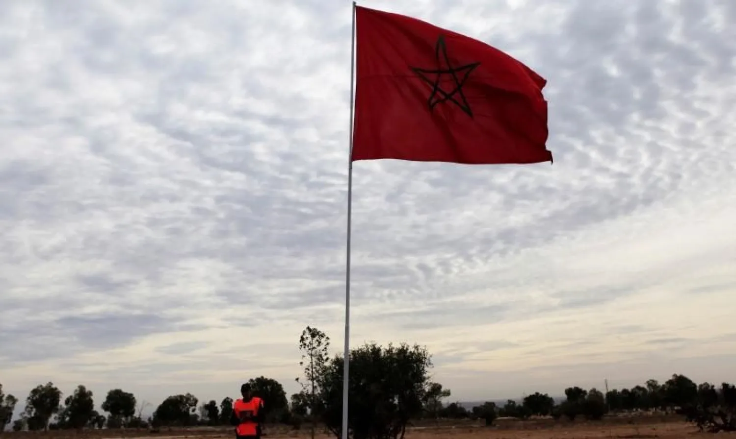 File photo of a police officer standing near a Moroccan national flag near the main stadium during preparations for the FIFA Club World Cup in Agadir, December 10, 2013. (Reuters)