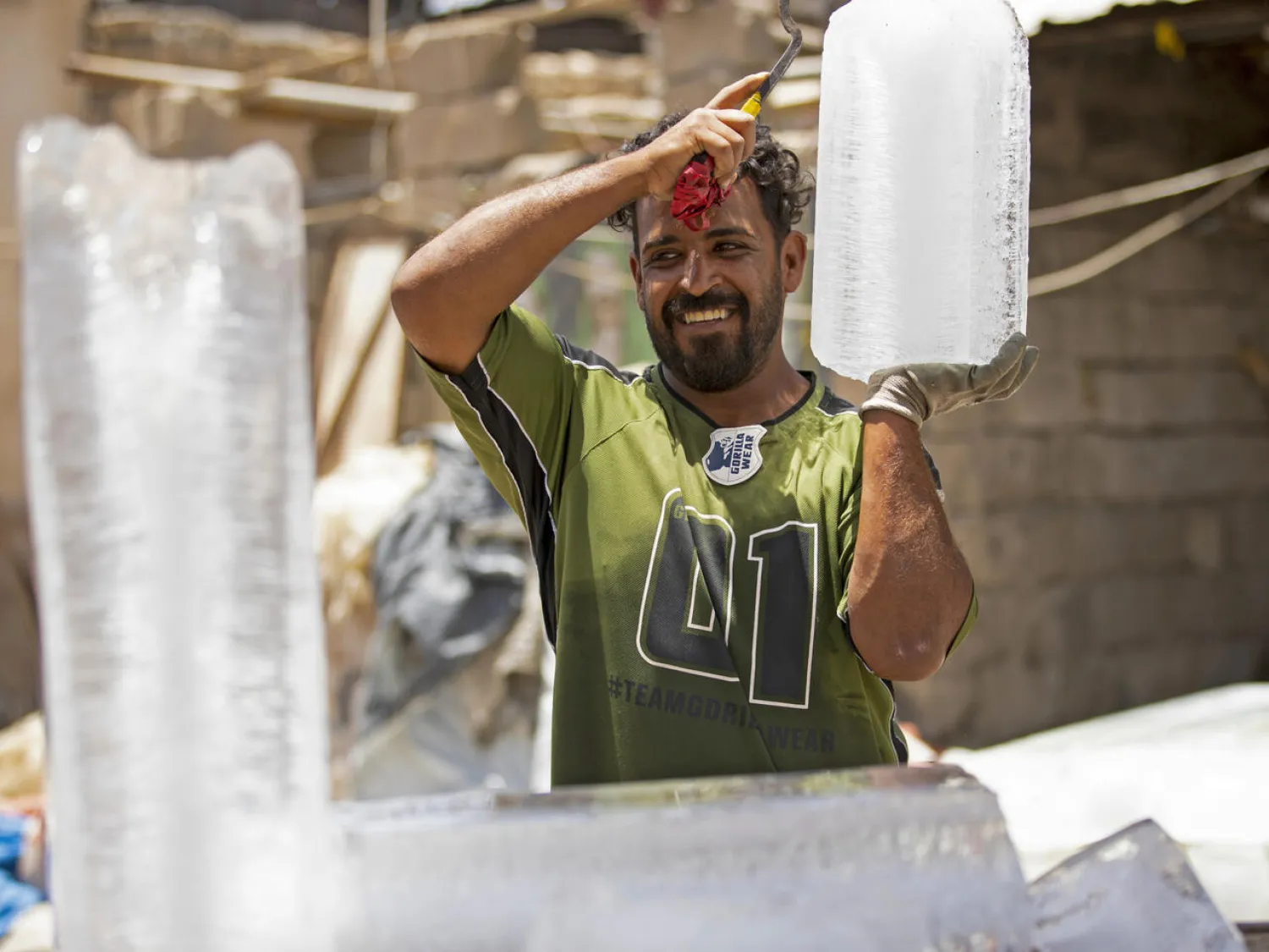 A man carries a block of ice at his stall in Iraq's southern city of Basra. Hussein Faleh AFP
