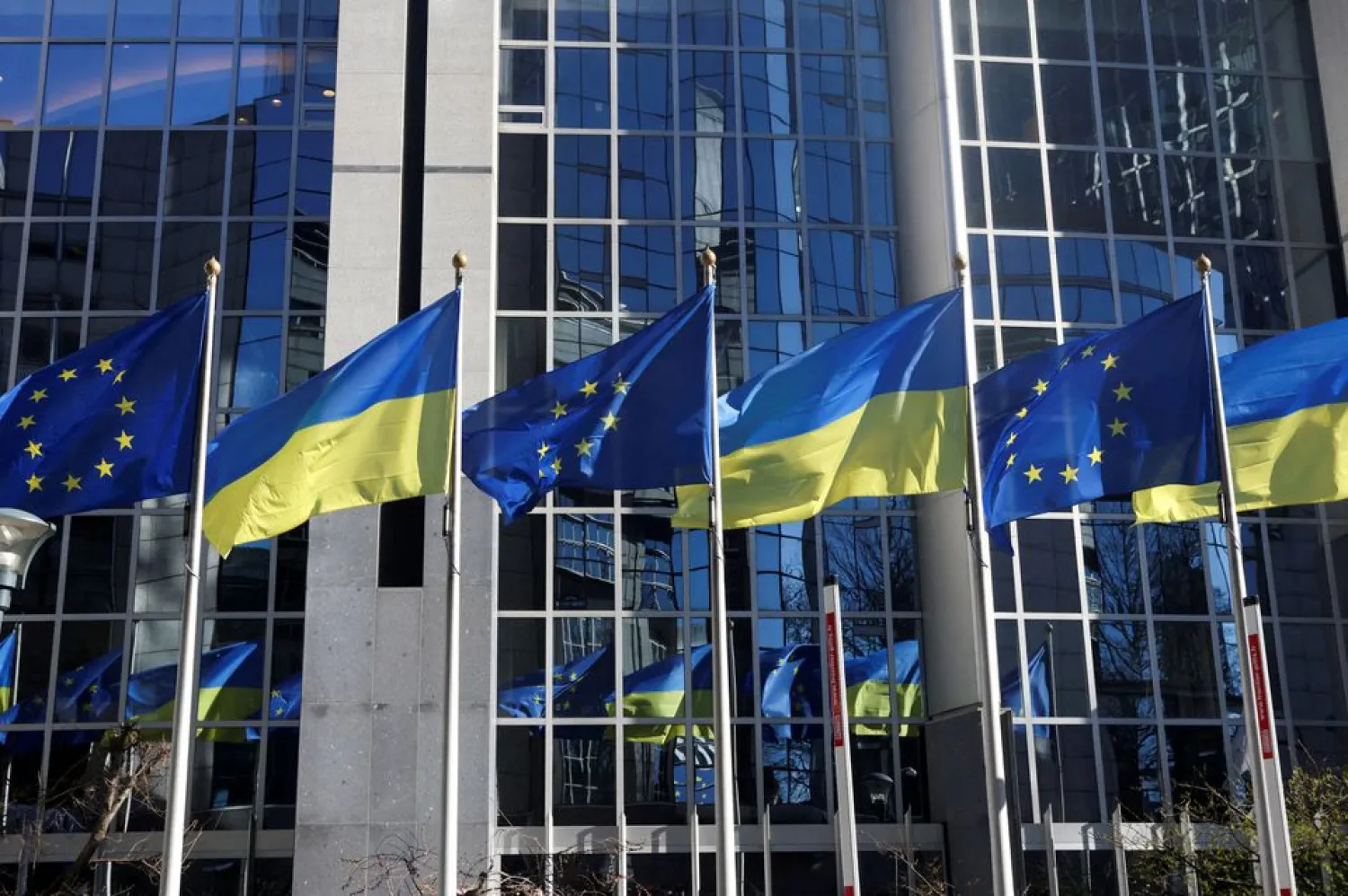 The flags of the European Union and Ukraine flutter outside the European Parliament building, in Brussels, Belgium, February 28, 2022. REUTERS/Yves Herman/File Photo