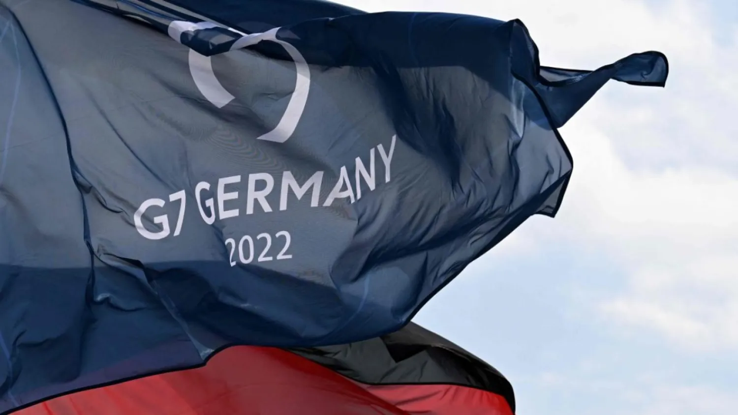 A German national flag and a flag for the G7 Summit fly in the wind in Garmisch-Partenkirchen. Credit: AFP Photo