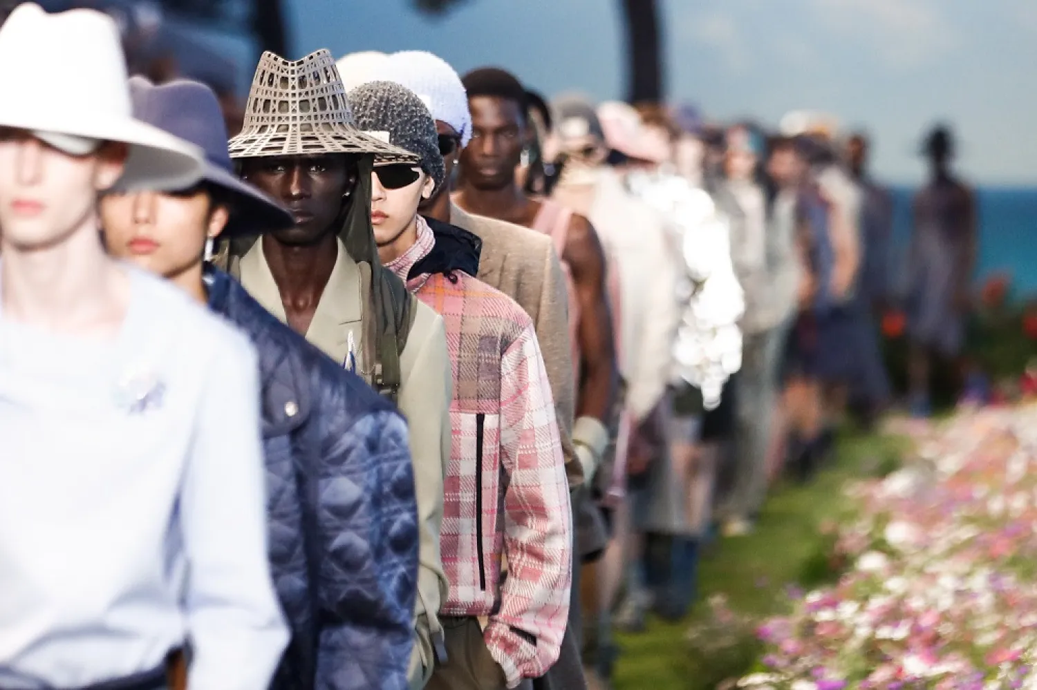 Models present creations from the Spring / Summer 2023 Men's collection by designer Kim Jones for Dior Homme during the Paris Fashion Week, in Paris, France, 24 June 2022. (EPA)