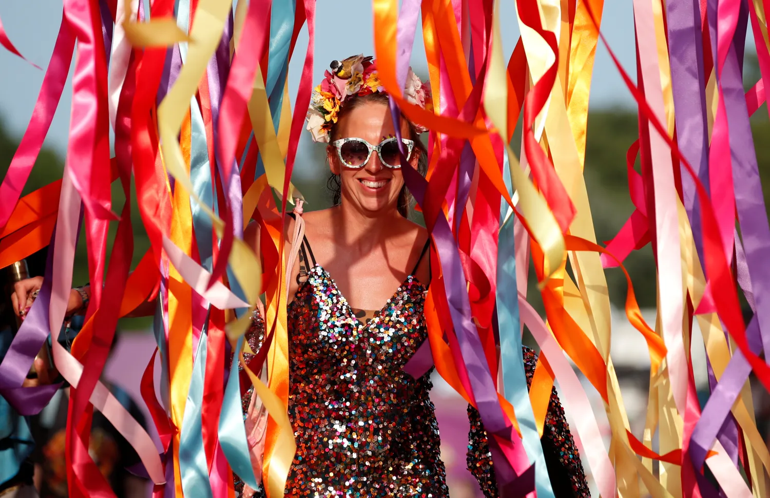 A festivalgoer walks through ribbons at Latitude Festival at Henham Park, Britain, July 22, 2021. REUTERS/Peter Cziborra