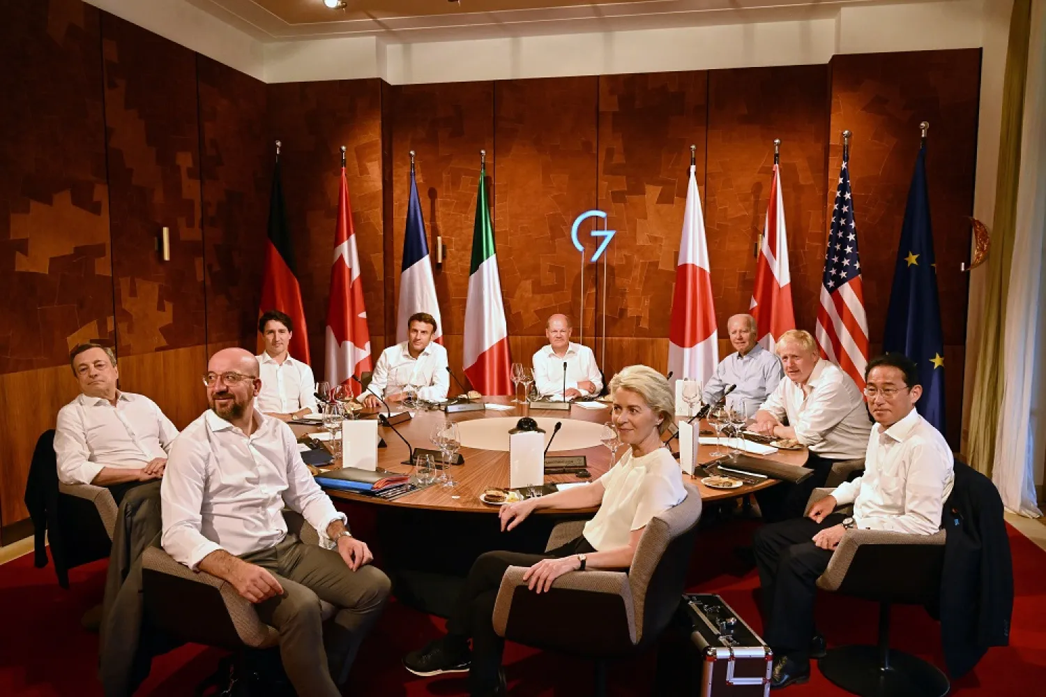 (L-R) Italy's Prime Minister Mario Draghi, European Council President Charles Michel, Canada's Prime Minister Justin Trudeau, France's President Emmanuel Macron, Germany's Chancellor Olaf Scholz, European Commission President Ursula von der Leyen, US President Joe Biden, Britain's Prime Minister Boris Johnson and Japanese Prime Minister Fumio Kishida attend a working dinner session on the first day of the three-day G7 summit at Schloss Elmau near Garmisch-Partenkirchen, Germany, 26 June 2022. (EPA)