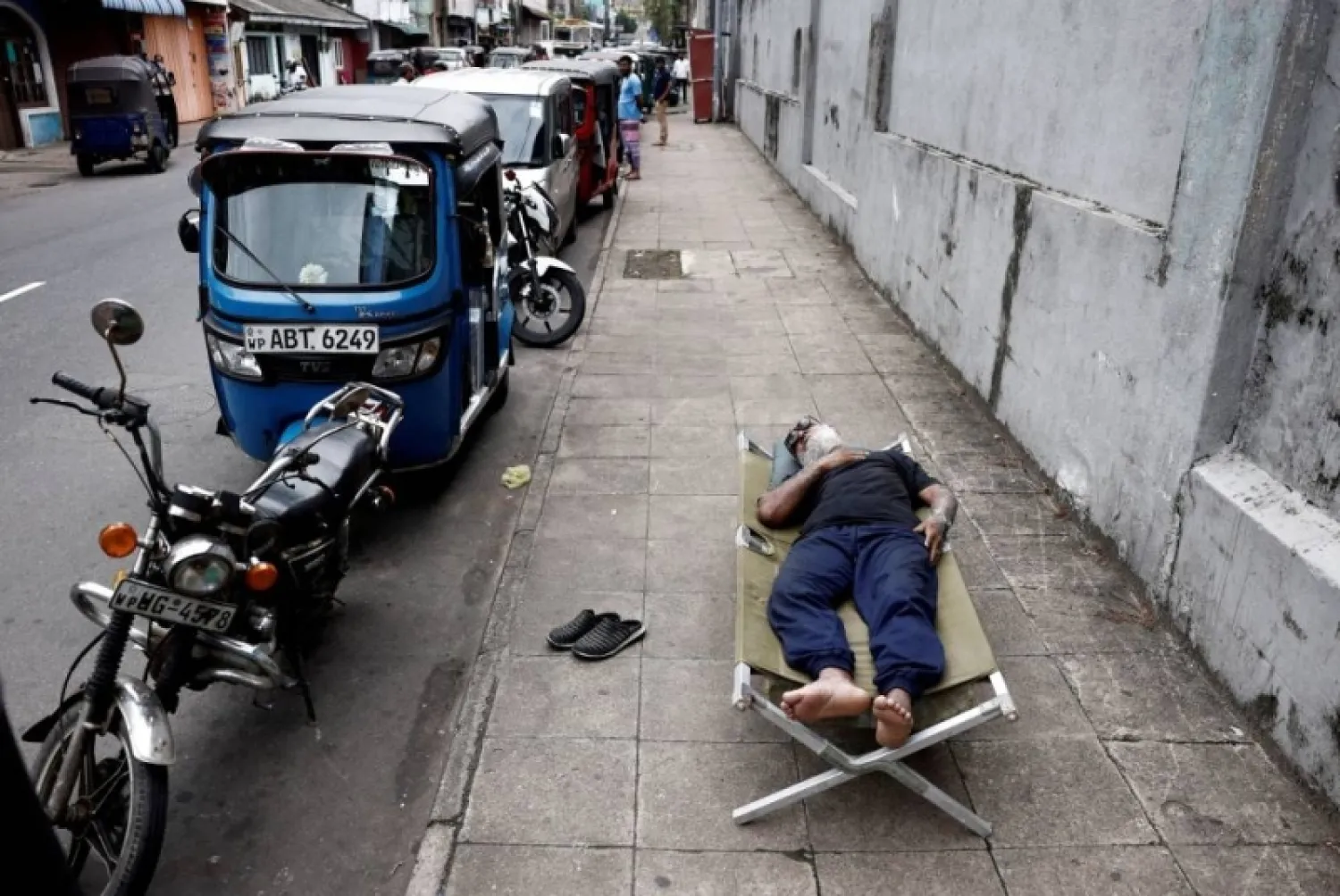A man sleeps on a folding bed on a pavement as he waits in queue to buy petrol due to fuel shortage, amid the country's economic crisis, in Colombo, Sri Lanka June 17, 2022. Reuters pic
