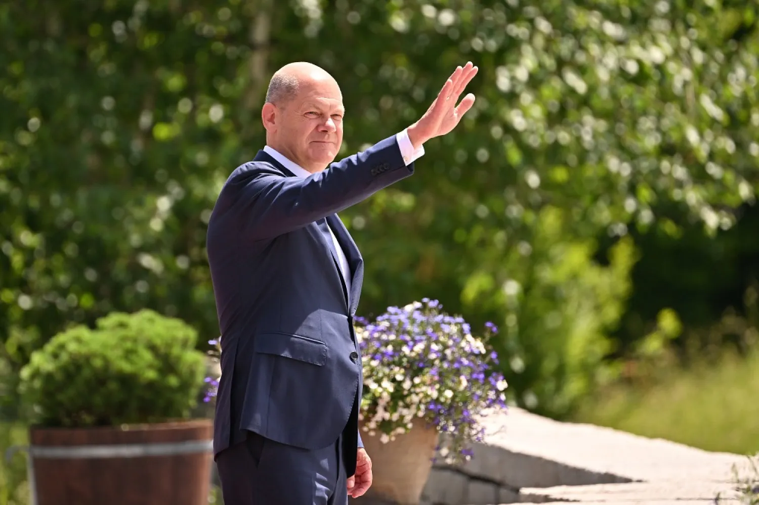 German Chancellor Olaf Scholz greets guests attending the outreach program on the second day of the three-day G7 summit at Elmau Castle, in Kruen, Germany, 27 June 2022. (EPA)