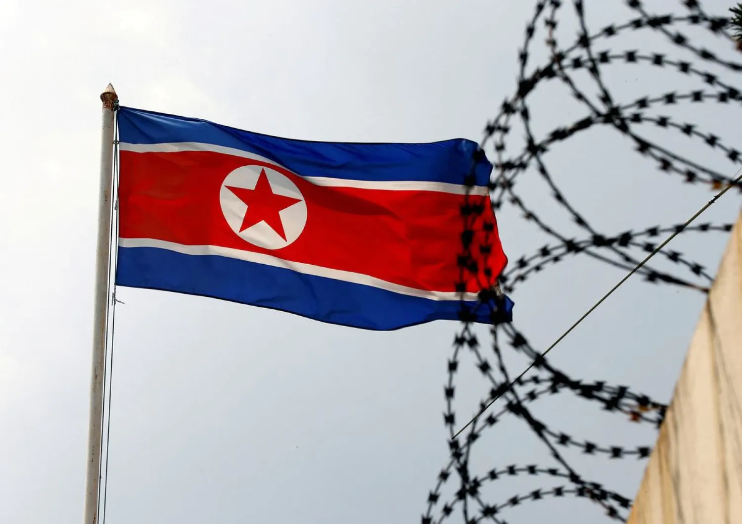 A North Korea flag flutters next to concertina wire at the North Korean embassy in Kuala Lumpur, Malaysia March 9, 2017. REUTERS/Edgar Su

