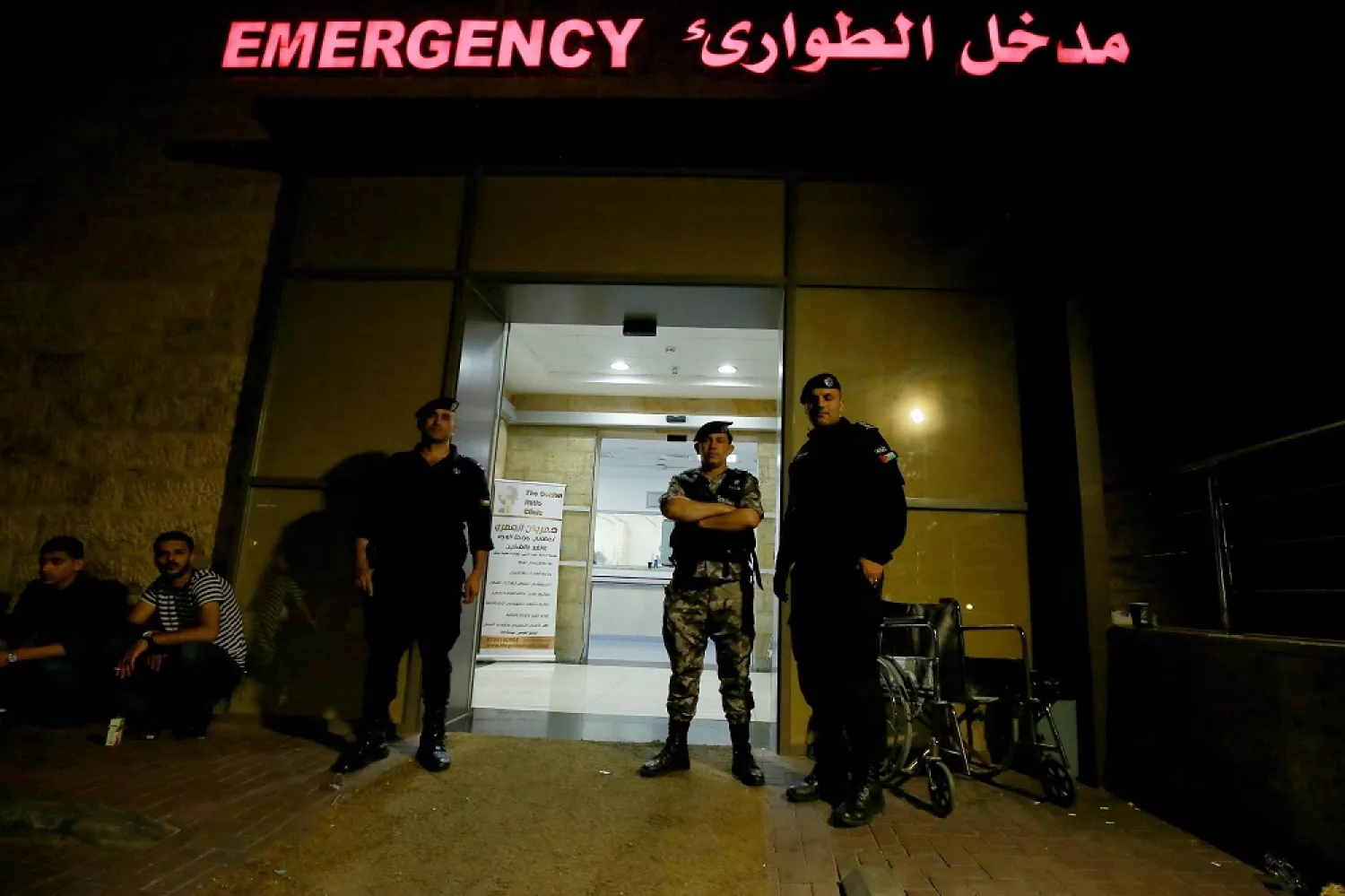Jordanian security forces stand guard at the entrance of the emergency ward of a hospital late on June 27, 2022 in the Jordanian Red Sea resort of Aqaba following a toxic gas explosion in the port of the Red Sea resort earlier in the day. (AFP)