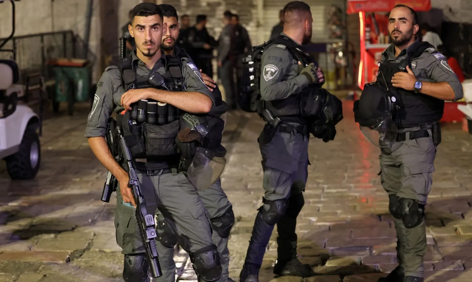 Israeli border guards stand guard as they close all access to the Damascus Gate of the old city of Jerusalem amidst heightened security measures late on June 28, 2022. (AFP) 
