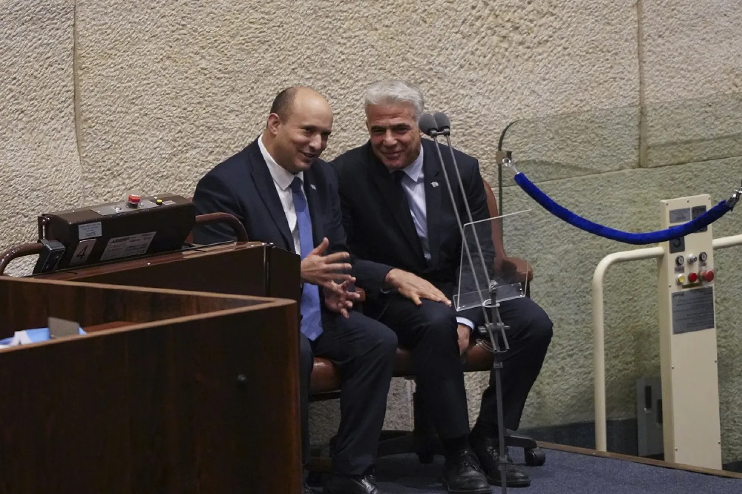 Israeli Prime Minister Naftali Bennett, left, and Foreign Minister Yair Lapid speak at the Knesset, Israel's parliament, in Jerusalem, Monday, June 27, 2022. (AP) 