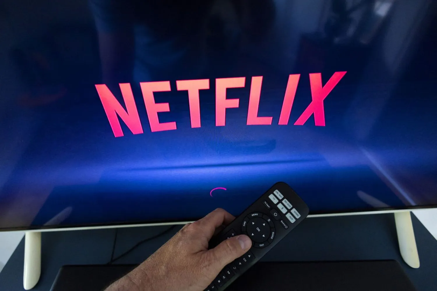 A Netflix logo is shown on a TV screen. Reuters