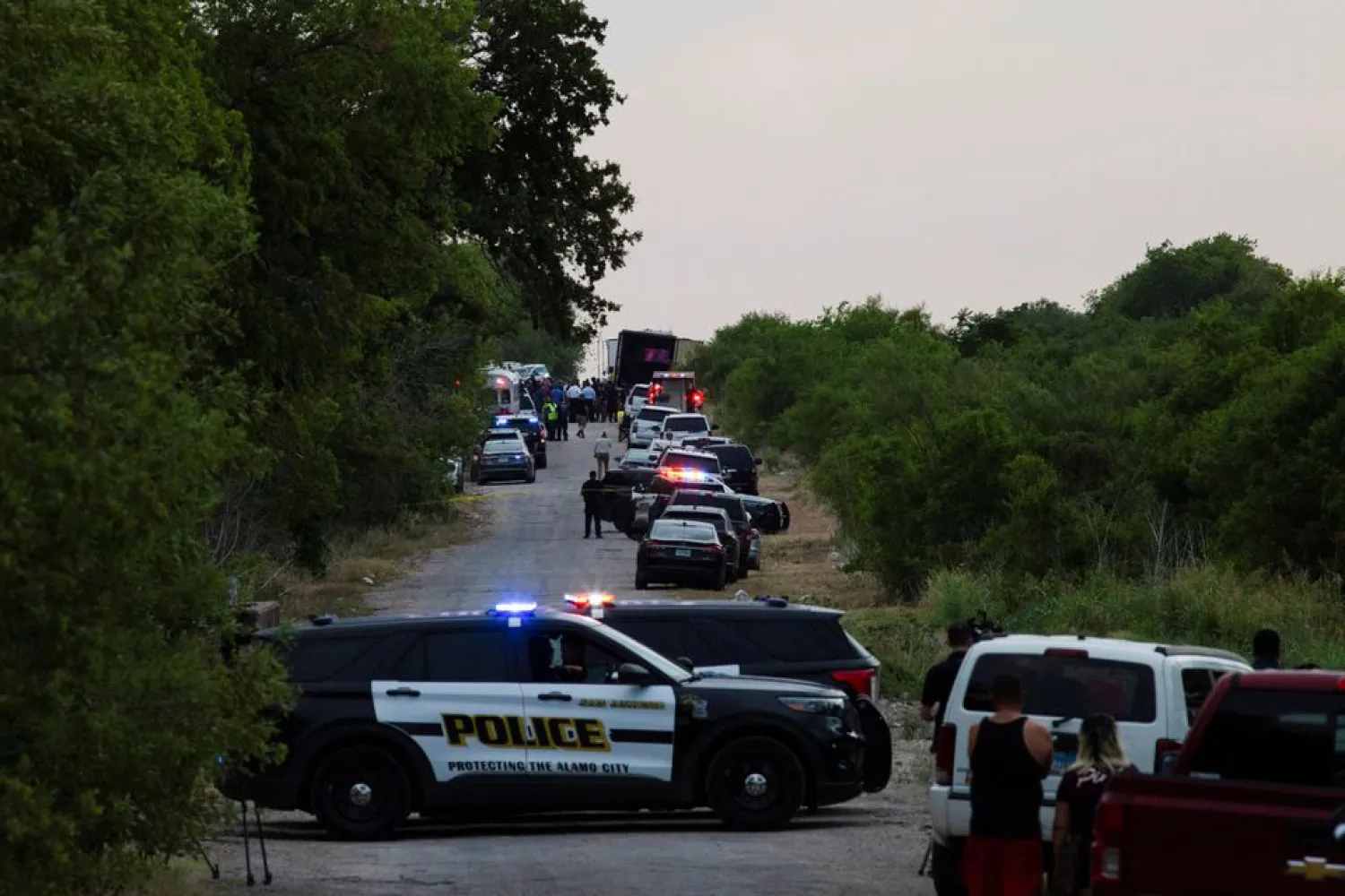 Law enforcement officers work at the scene where people were found dead inside a trailer truck in San Antonio, Texas, US June 27, 2022. REUTERS/Kaylee Greenlee Beal