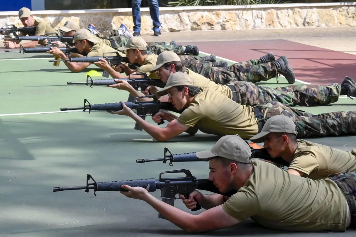 Lebanese school students train on how to use weapons during an open day at the headquarters of the Lebanese Army Military Academy at Shukri Ghanem barracks in Faiyadiyeh east of Beirut, Lebanon, 30 June 2022. (EPA)