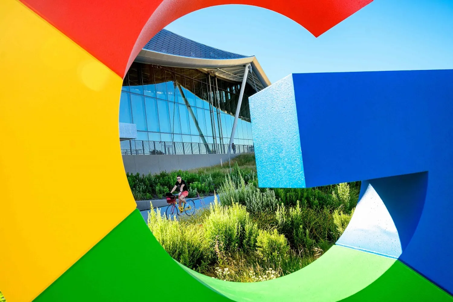 A bicyclist rides along a path at Google's Bay View campus in Mountain View, California on June 27, 2022. (AFP) 