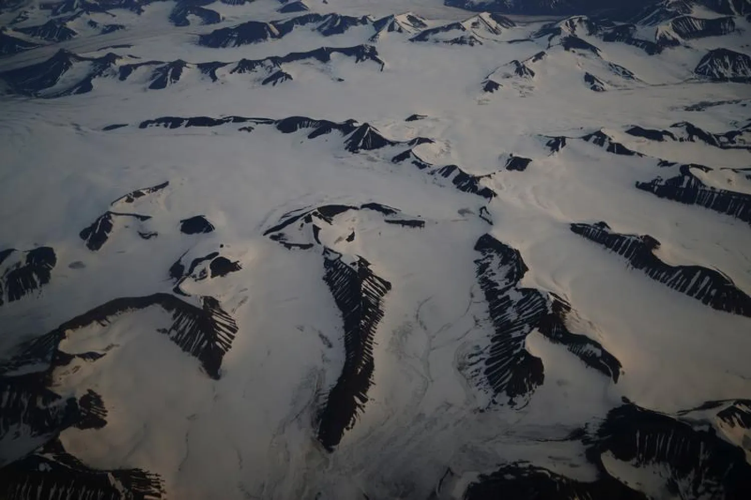 FILE PHOTO: An aerial view shows snow-covered mountains in Svalbard, August 3, 2019. REUTERS/Hannah McKay/File Photo
