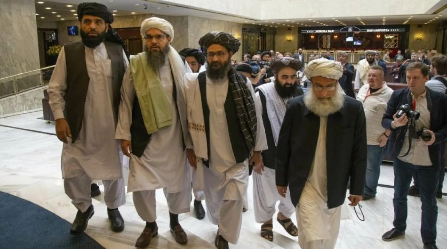 FILE - In this May 28, 2019 file photo, Mullah Abdul Ghani Baradar, the Taliban group's top political leader, third from left, arrives with other members of the Taliban delegation for talks in Moscow, Russia. (AP Photo/Alexander Zemlianichenko, File)
