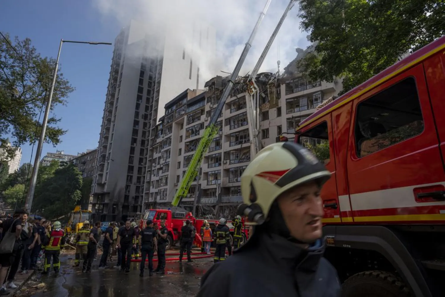 Firefighters work at the scene of a residential building following explosions, in Kyiv, Ukraine, June 26, 2022. (AP)
