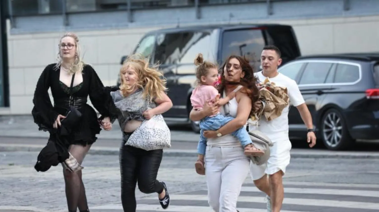 People react in front of the Fields shopping center in Copenhagen, Denmark, 03 July 2022. EPA/Olafur Steinar Rye Gestsson